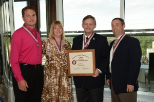 Jason Scott (left) receiving his Fellow designation at the 2014 Annual Meeting with other Fellow recipients Brenda DeBastiani, Bruce Hammond, and Jason Newmark.